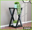 Modern black 2-tier flower pot display stand with plants in a bright living room corner