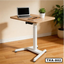 Adjustable laptop table with wooden top, white metal legs, and office setup in modern room