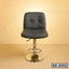 Modern black leather bar stool with chrome base on beige background, adjustable height chair