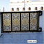 Modern CNC cutting boundary gate with intricate gold and black floral patterns, outdoor setting