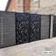 Modern CNC-cut metal boundary gate with decorative leaf pattern, installed at a house