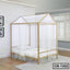 Modern wooden canopy bed frame with white netting in a bright bedroom