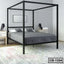 Modern black metal canopy bed frame in minimalist bedroom with gray bedding and nightstands