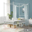 Modern white metal canopy bed frame with sheer curtains in a stylish bedroom setting