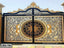 Decorative wrought iron gate with gold floral and geometric patterns, double entry design