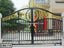 Decorative black and gold wrought iron boundary gate with ornate floral patterns, model CBG-715.
