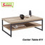 Modern wooden center table with black metal frame, open shelf, and minimalist decor items
