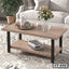 Modern wooden center table with black legs in a living room, decorated with a flower vase and tray.