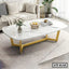 Modern marble top center table with gold metal legs in a stylish living room setup