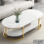 Modern oval white center table with gold metal legs and lower shelf, vase with flowers