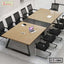 Modern conference table with metal legs and black mesh chairs in a boardroom setting
