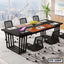 Modern rectangular conference table with black mesh chairs in a bright office setting