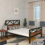 Modern double steel bed with wooden accents in a bright bedroom with curtains and decor.