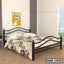Black metal double bed with decorative frame and printed bedding in a modern bedroom