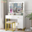 Modern white dressing table with mirror lights, storage drawers, cushioned stool, and decor items.