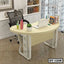 Modern executive table with laptop, books, mesh office chair, and decorative items in home office