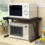 Modern kitchen shelf organizer holding a microwave and oven on a countertop