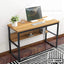Modern wooden laptop table with metal frame, shelf, computer monitor, and decor in home office