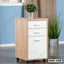 Modern wooden office drawer unit with three white drawers and caster wheels in a room setting