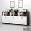 Modern office file cabinet with white doors, open shelving, binders, and printers in workspace.