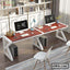 Modern dual office workstation desk with computers, chairs, and bookshelves in a bright office
