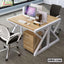 Modern office workstation desk with computers, divider, chairs, and storage drawers