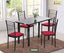 Modern black dining table with four chairs featuring red cushions, set on a brown rug in a bright room