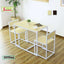 Modern rectangular dining table with two chairs, light wood top and white metal frame, indoor setting