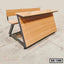 Wooden school bench with attached desk and metal frame, suitable for classroom seating