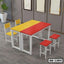 Colorful school bench set with yellow and red rectangular table, metal frame, and matching chairs.