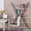 Modern black and white metal shelf with books and decor in a stylish dining room