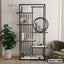 Modern black metal bookshelf with geometric design, books, decor, vases, and indoor plant