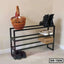Modern black metal shoe rack with multiple tiers, holding shoes, a basket, and a box.