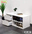 Modern white shoe rack with shelves and drawers, placed by a wall and decorated with plants.
