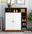 Modern wooden shoe rack with white doors, multiple shelves, and shoes organized neatly.