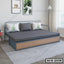 Modern metal sofa cum bed with gray mattress and decorative cushions in bright living room