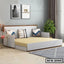 Modern sofa cum bed with cushions in a bright living room, ideal for home furniture in Bangladesh.