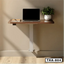 Wall-mounted standing laptop table with plant, notebook, and modern minimalist design