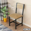 Modern steel dining chair with wooden seat and backrest placed in a contemporary room