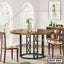 Round steel dining table with wooden top, two chairs, in a modern dining room setting