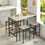Modern steel dining table set with four matching stools in a bright kitchen setting