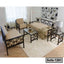 Modern steel frame sofa set with beige cushions and glass tables in a bright living room