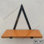 Modern wooden wall shelf with black metal triangular bracket, ideal for home and office decor.