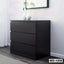 Modern black wooden wardrobe with three drawers in a minimalist bedroom setting