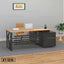 Modern executive office desk with wooden top, black metal frame, leather chair, and laptop.