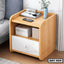 Modern wooden bedside table with drawer and shelf, light finish, decorated with books and clock