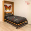 Modern wall bed with black bedding, wooden frame, butterfly wall art, and light wood floor