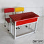 Red school desk with two chairs, one red and one yellow, on a white background