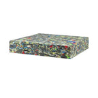 Rectangular block of multi-colored rebonded foam sheet on white background