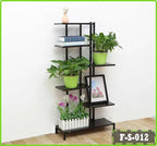 6-tier indoor flower rack with potted plants, books, and a photo frame against a wall